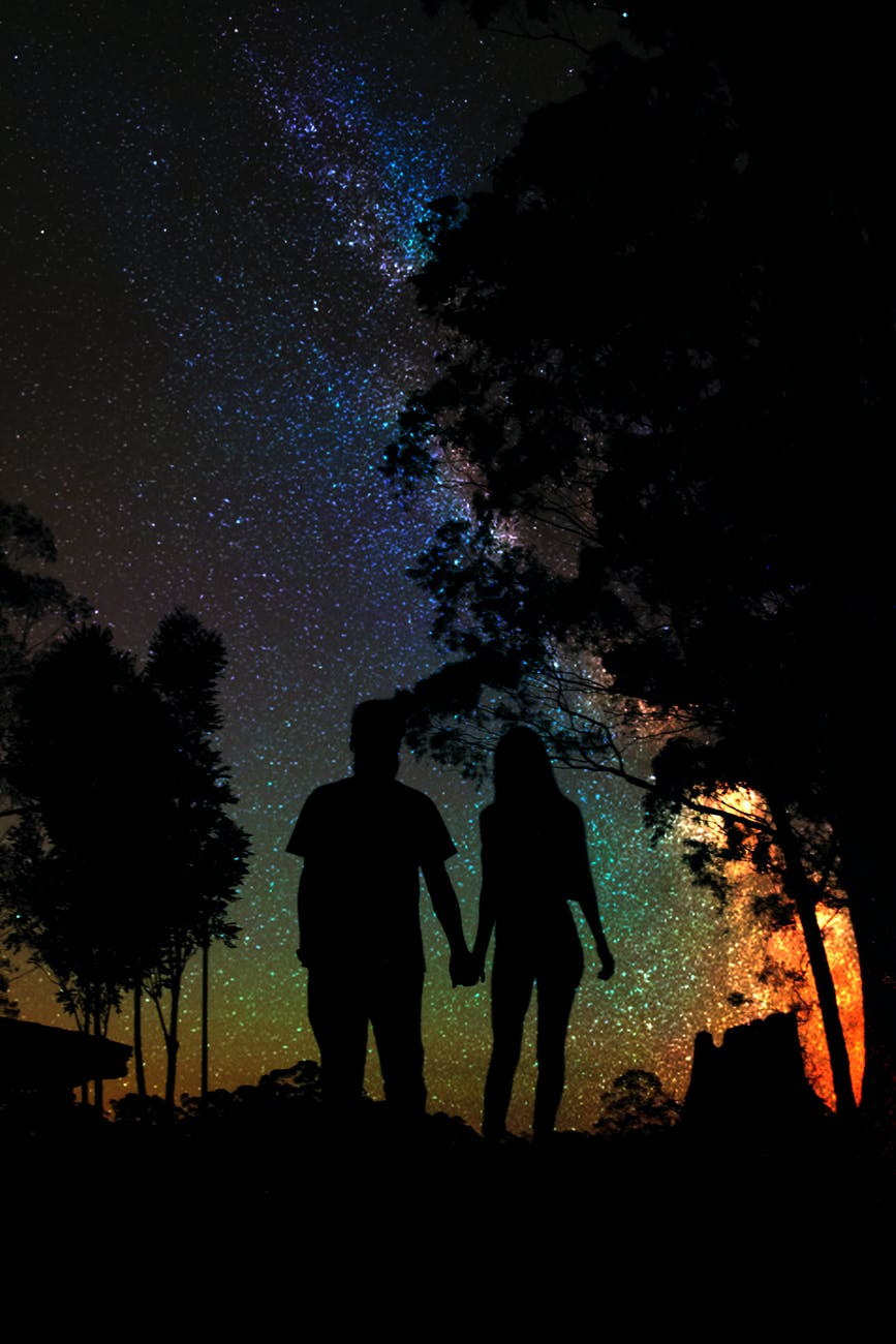 silhouette of man and woman holding hands