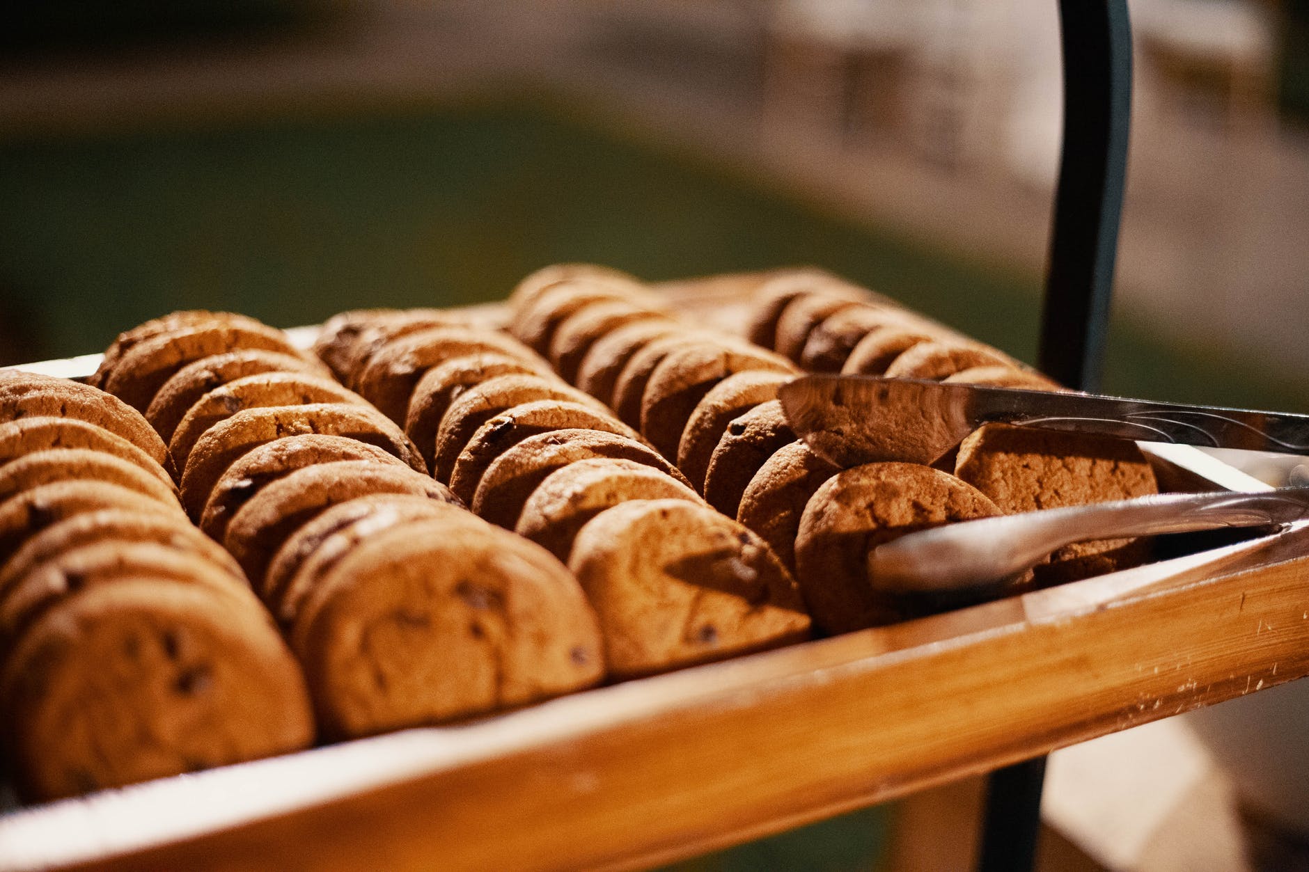 selective focus photography of baked cookies with gray stainless steel tong