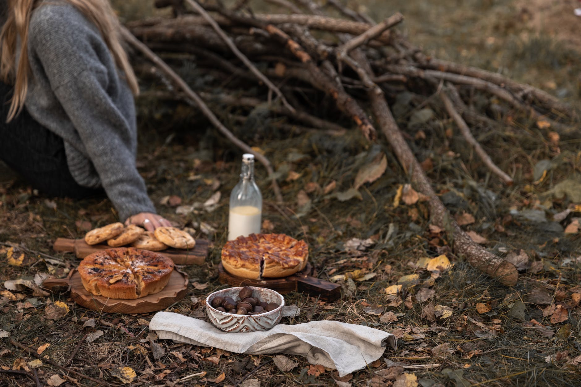 woman sitting on the ground with a bunch of snacks